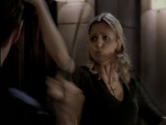 Buffy fights Angel, lips pursed